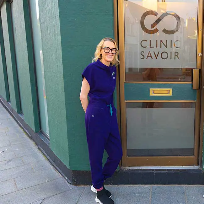 clinic-savoir Noventre client testimonial, shows ckient standing in front of clinic savoir offices.
